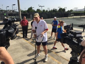 Mayor Battle speaking to media at tennis court