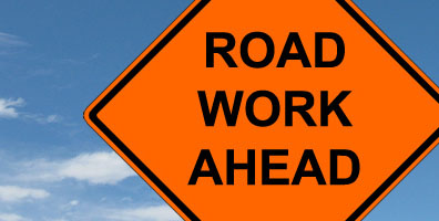 image of a roadwork ahead sign in orange