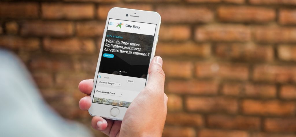 A photo of individual viewing City Blog on their phone