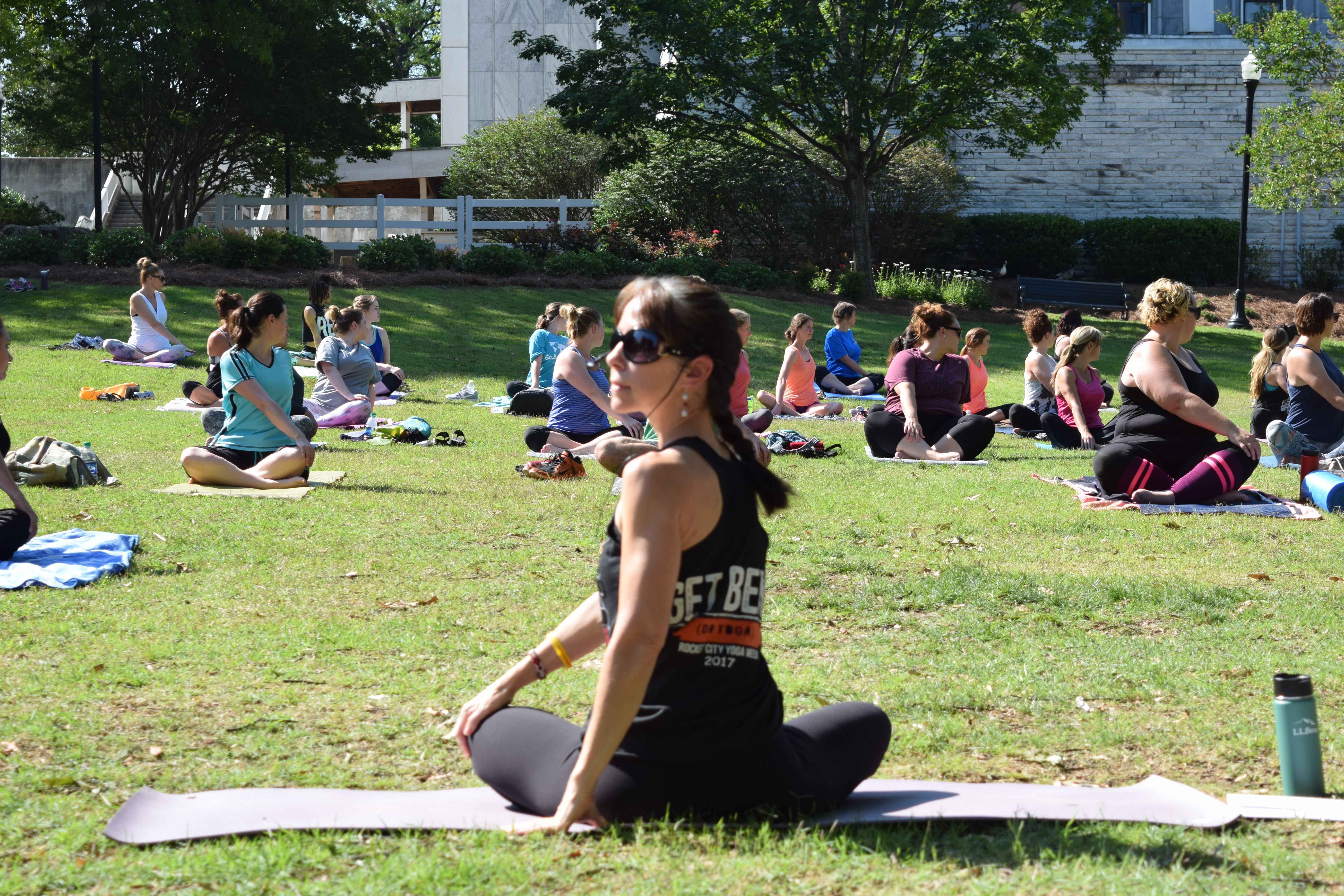 woman teaching a yoga class in the park