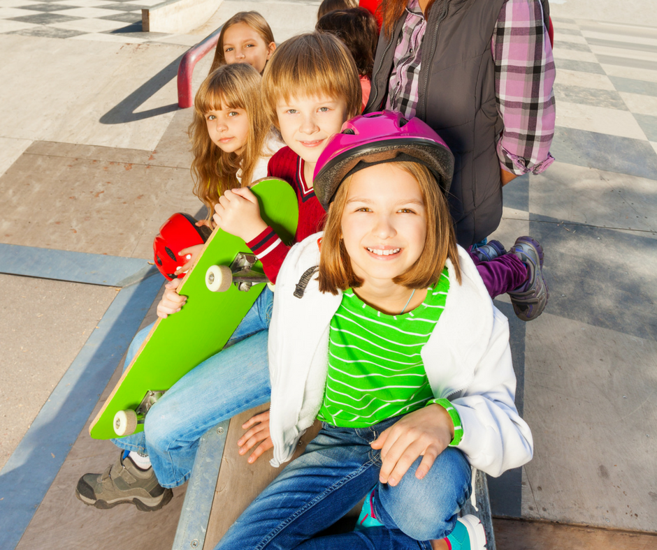 kids sitting at a skate park