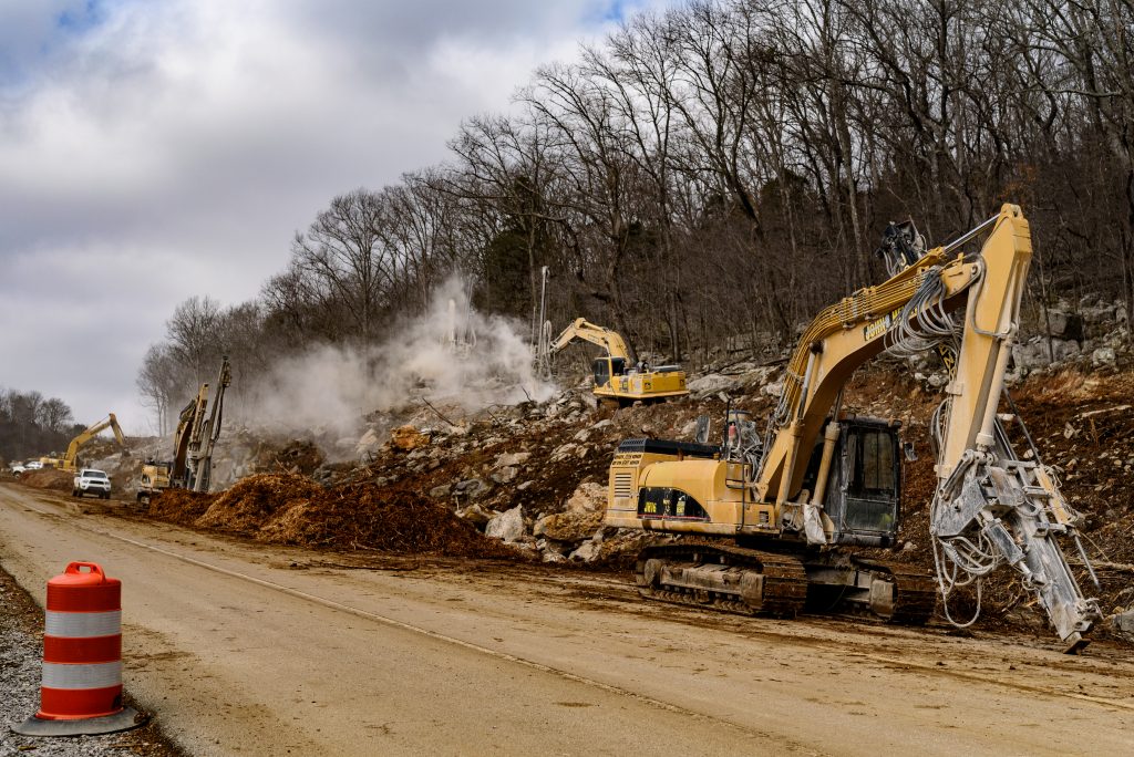 Heavy machinery digging through debris