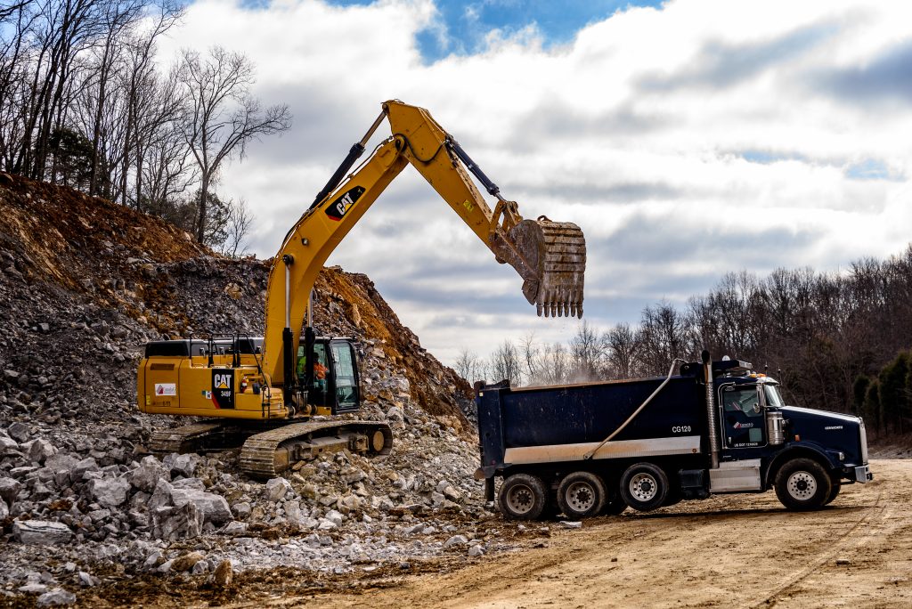 Dump truck removing debris from work site