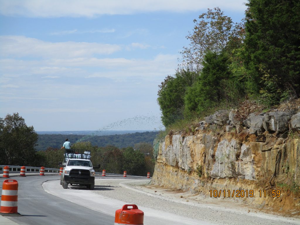 Truck on Cecil Ashburn spraying while the road is under construction