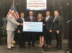 Photo of Redstone Federal giving $3 million check to the new cyber magnet school