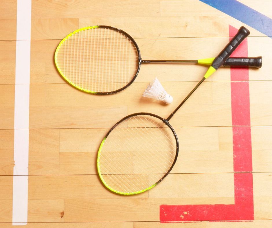 Two badminton racket on gym floor
