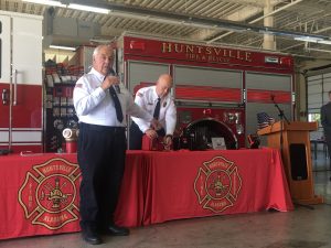 photo of fire chief demonstrating new security boxes for businessess that will allow firefighters access into closed buildings