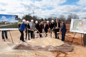 Mayor and leaders with shovels and hardhats pitching dirt at theSouth Huntsville Public Library groundbreaking