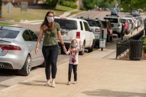 Photo of mother and her young daughter wearing a mask