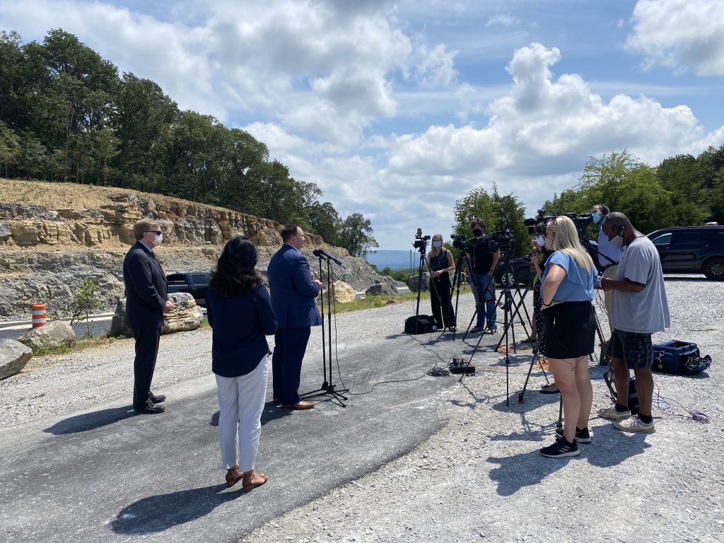 mayor battle and city engineers speak to media in the land trust parking lot overlooking Cecil Ashburn Drive