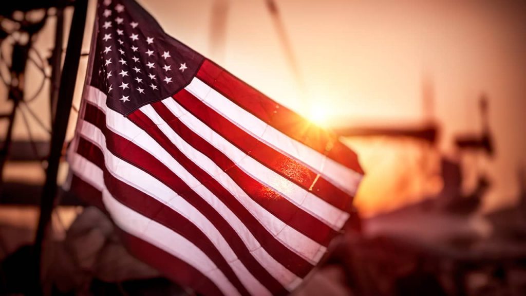 photo of an american flag at sunset