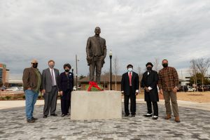 city leaders and members of the WHCAA pose in front of the newly unveiled statue of Dr. Councill
