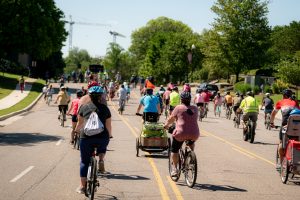 Dozens of people riding on their bicycles on a road in Huntsville.