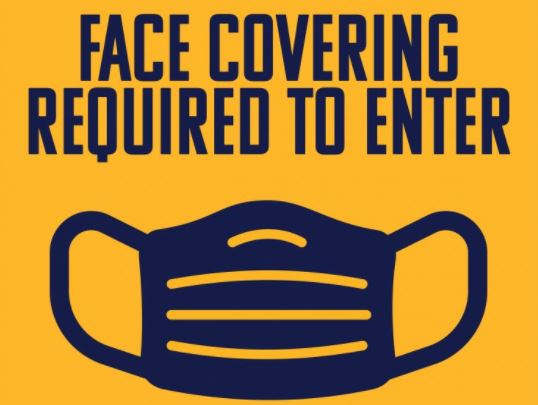 A graphic with an image of a face covering and the words Face Covering Required to Enter