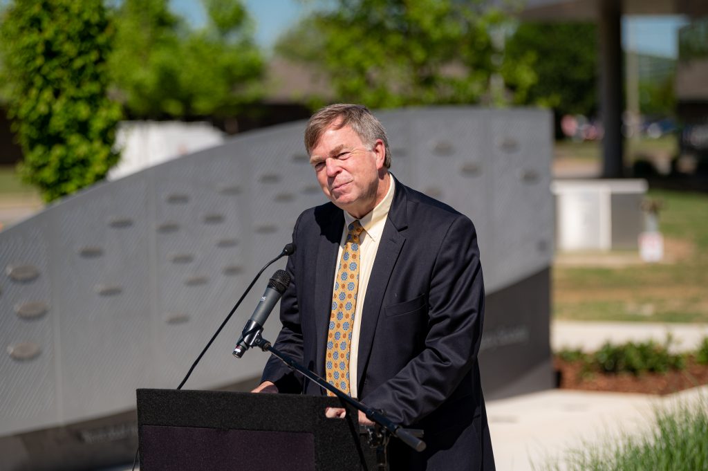 Mayor speaking at a podium in an outdoor park