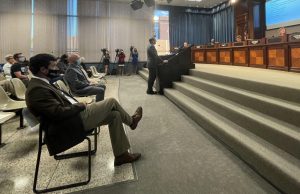 Huntsville City Administrator John Hamilton stands at the podium in the City Council Chambers during a presentation about a Co-Response Program. Looking on are Jeremy Blair, executive director of WellStone Behavioral Health, and Lt. Jon Ware, HPD’s CIT coordinator.