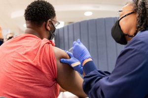 Nurse gives man COVID vaccine