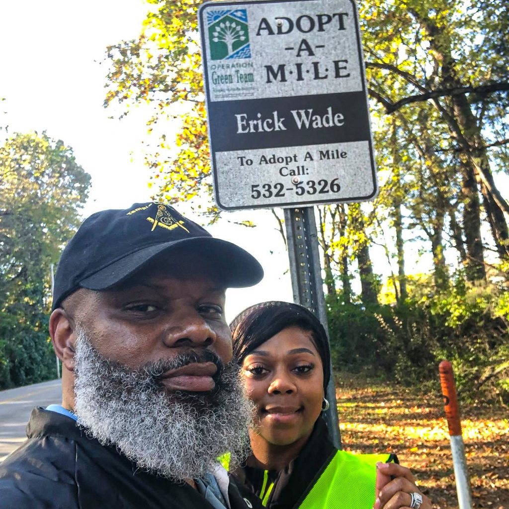 Erick Wade and LaChelle pose near Adopt-A-Mile sign
