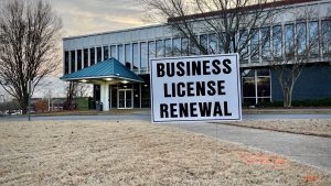 business license renewal sign in front of public services building