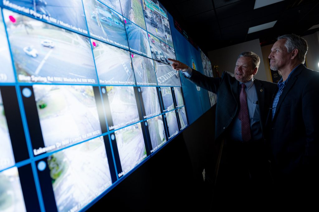 Chief McMurray and a member of the police department looking at a screen in the NAMACC