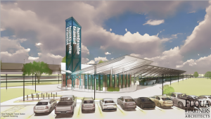 A proposed rendering of the new Huntsville Transit transfer station, which should open in 2024. There are cars in a parking lot and buses in bays in the background.