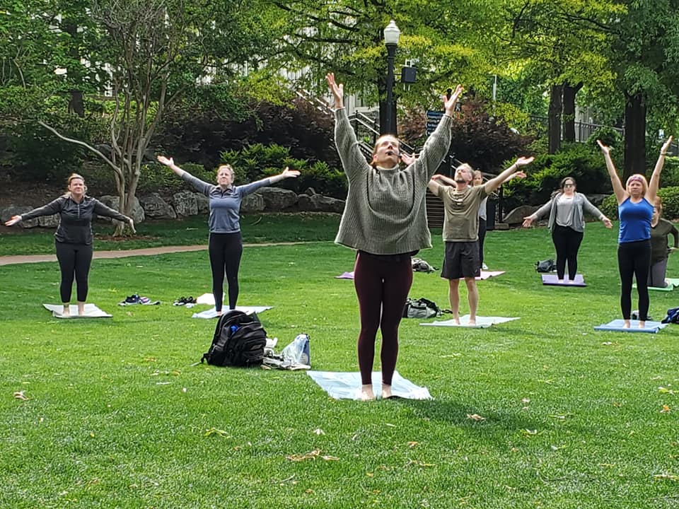 Picture of a yoga class outdoors in Big Spring Park