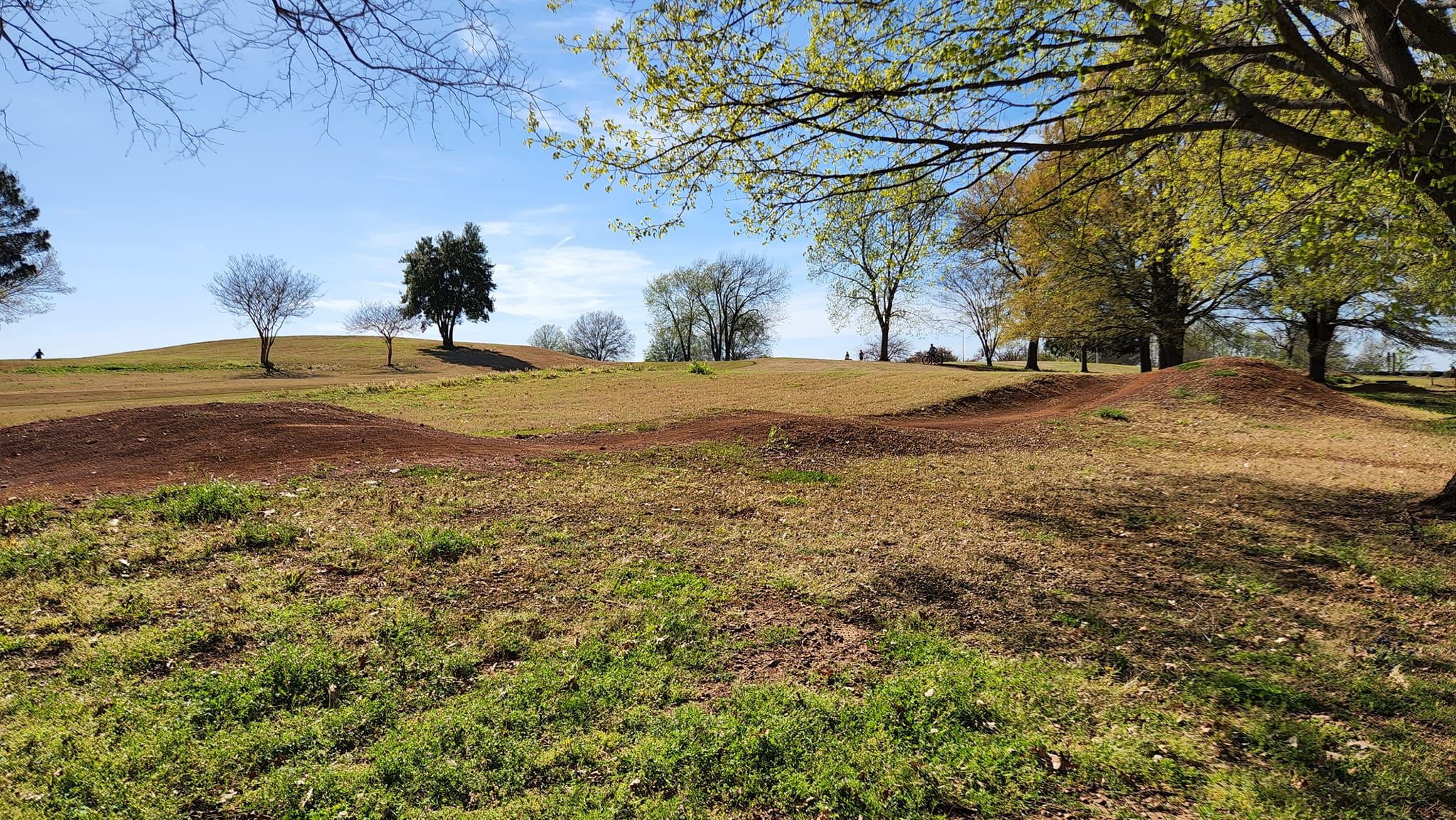 Photo of the landscape for the mountain bike course showing hills and rugged dirt path