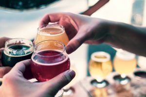 photo of hands holding full cups of craft beer