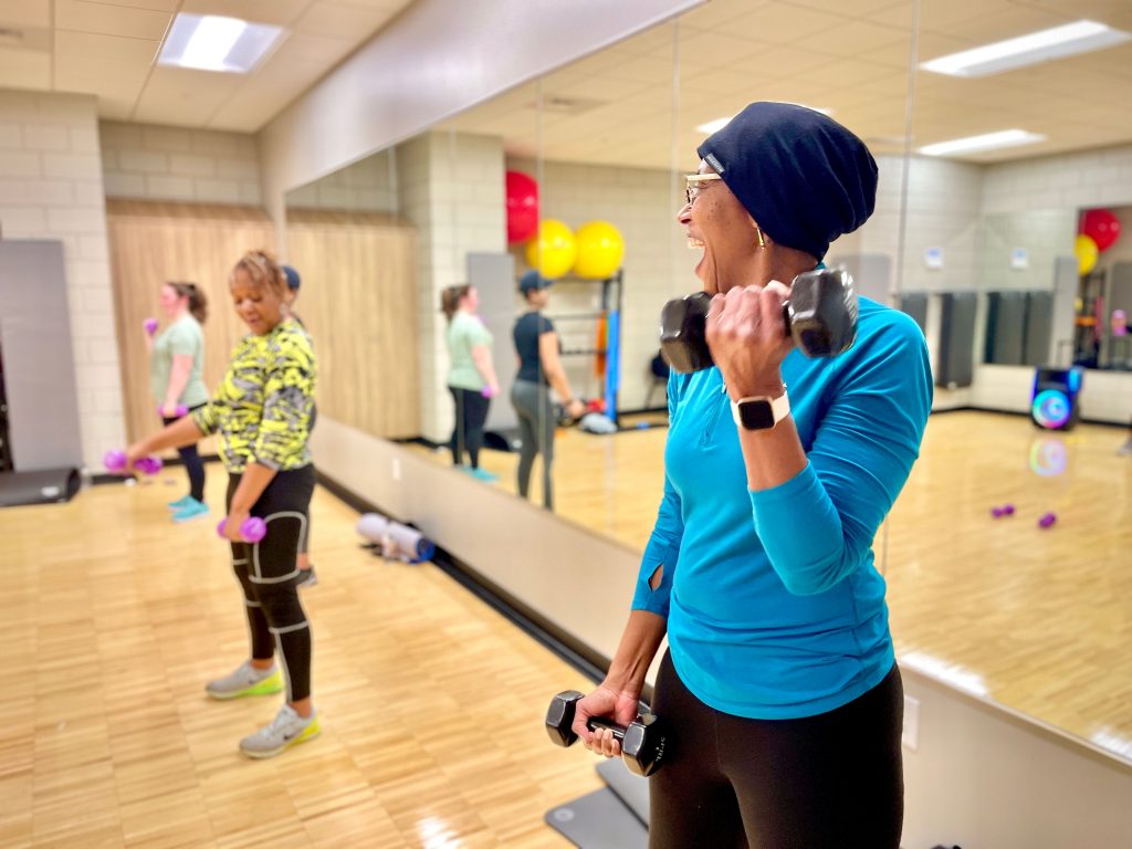 Two women work out and share a laugh at Johnson Legacy Center