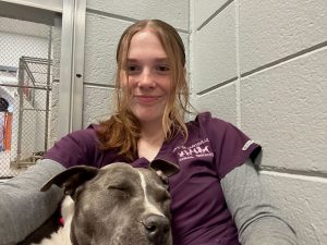 A Huntsville Animal Services worker poses for a selfie with Guerra, a mixed-breed dog.