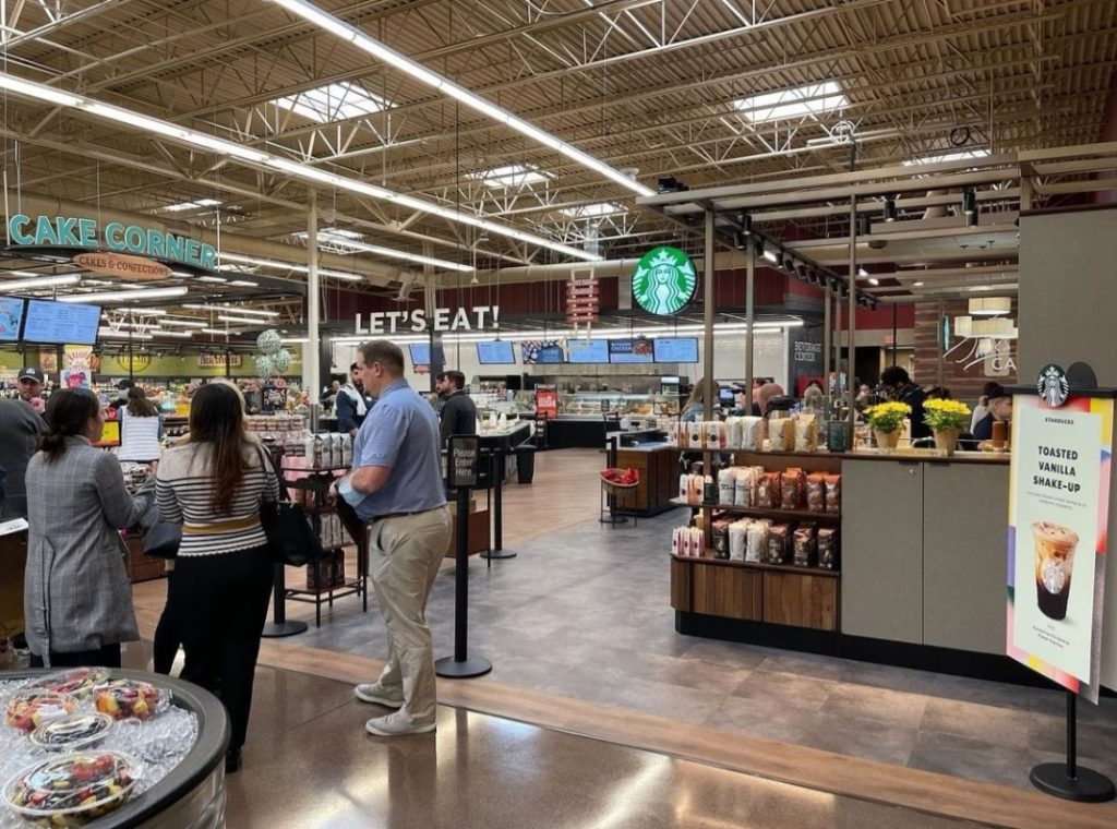 people shopping in a large grocery store