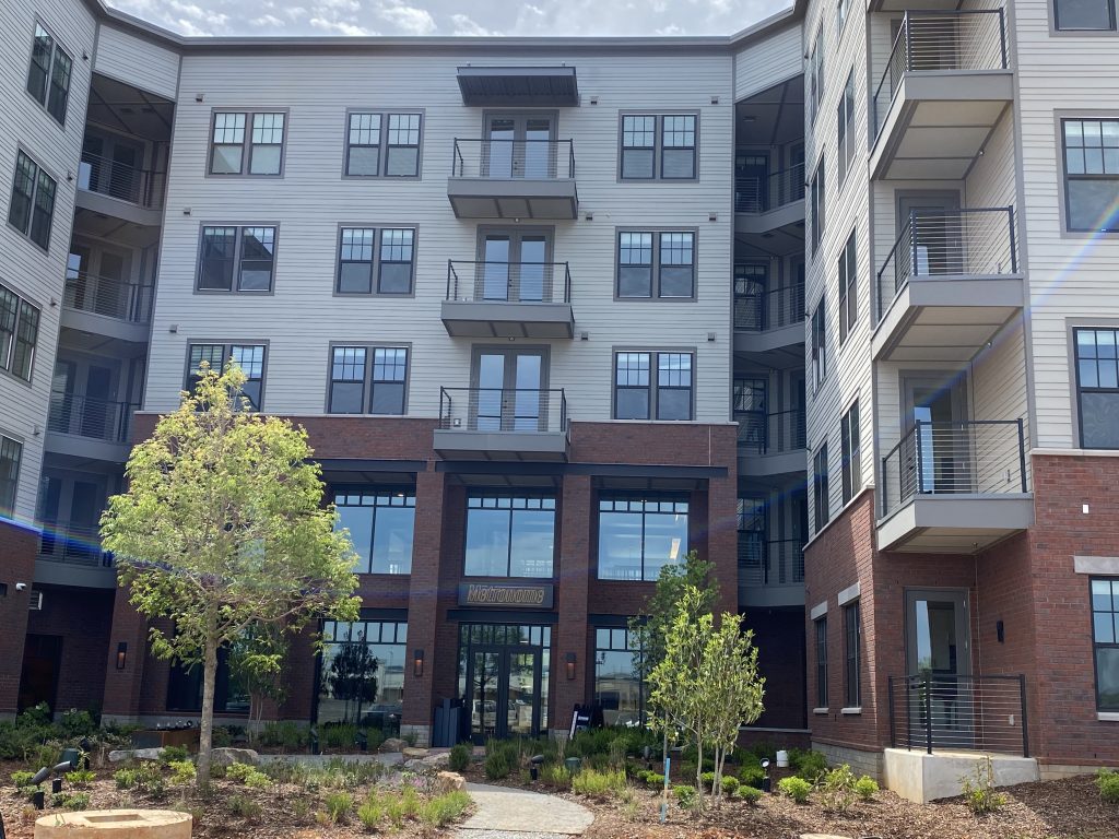 photo of the front entrance of a 5-story apartment building