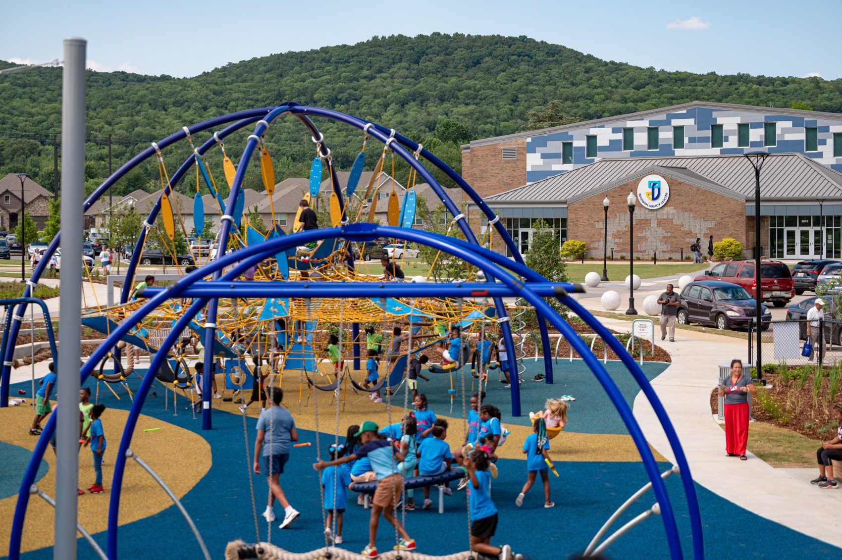 Children play on a playground during the grand opening of Legacy Park in Northwest Huntsville.