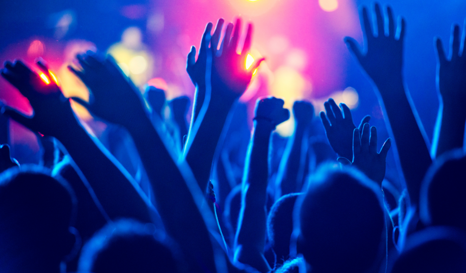 Hands raised in the air at a concert.