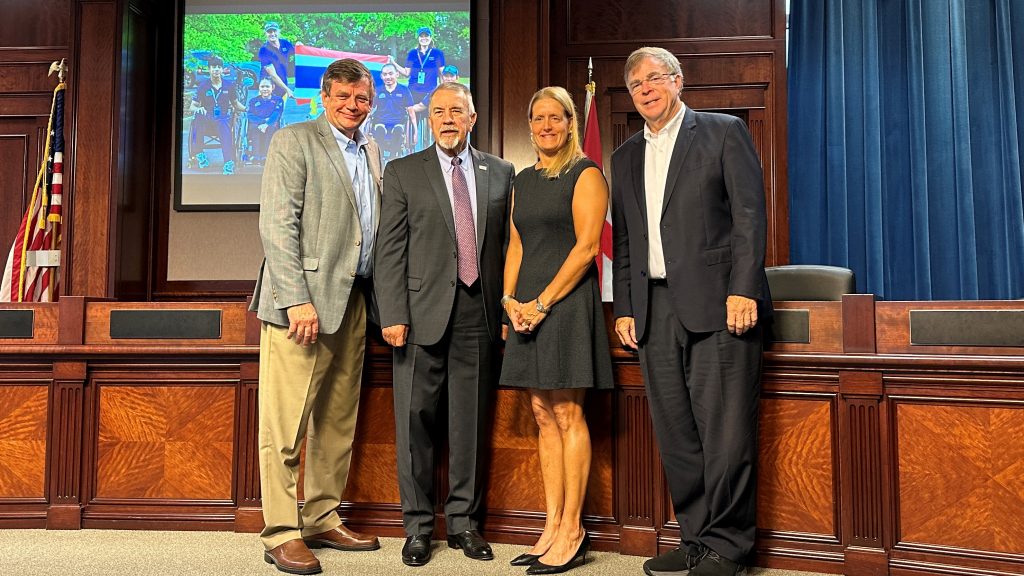 Mayor Tommy Battle poses for a photo with Huntsville Chamber President Chip Cherry, Madison County Commission Chairman Mac McCutcheon and Julie Dussliere, Chief of Paralymics and Internally Managed Sports at the United States Olympic & Paralympic Committee.