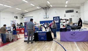 Breaking Down Barriers Attendees of Breaking Down Barriers talk to representatives sitting at booths inside recreation center