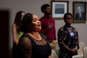 A woman sings during a City Council meeting in September 2022.