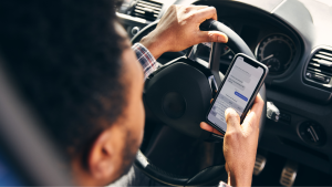 Text and drive Man texts on cell phone while driving vehicle