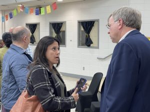 Mayor Tommy Battle speaks with a Huntsville resident at a Hispanic Community Town Hall at McDonnell Elementary School.