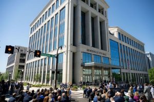 Several people outside a large building.