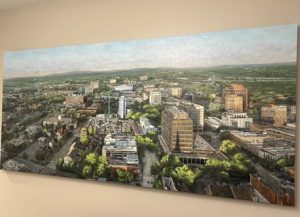 Artistic painting of downtown Huntsville with several buildings and trees
