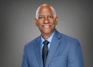 man poses for portrait in blue suit