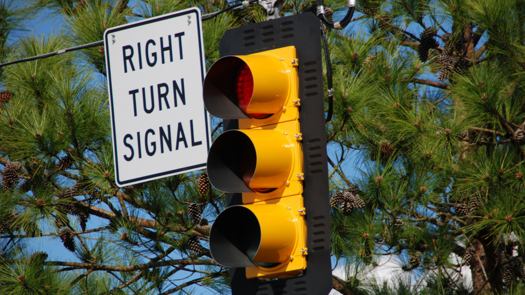 yellow traffic signal with right turn signal sign