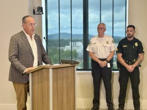 District 2 Council Member David Little speaking at podium at the Hands-Free One-year Anniversary news conference alongside HPD Chief Kirk Giles and HPD Public Information Officer Sgt. Chris Jackson