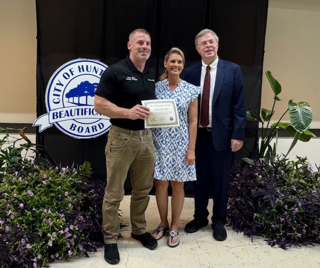 Mayor Battle presents the Mayor's 2025 Beautification Award to Flint River Animal Hospital at Awards Ceremony