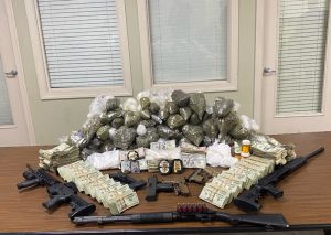 Some of the illegal drugs, money and weapons seized in Operation New Heights on a table
