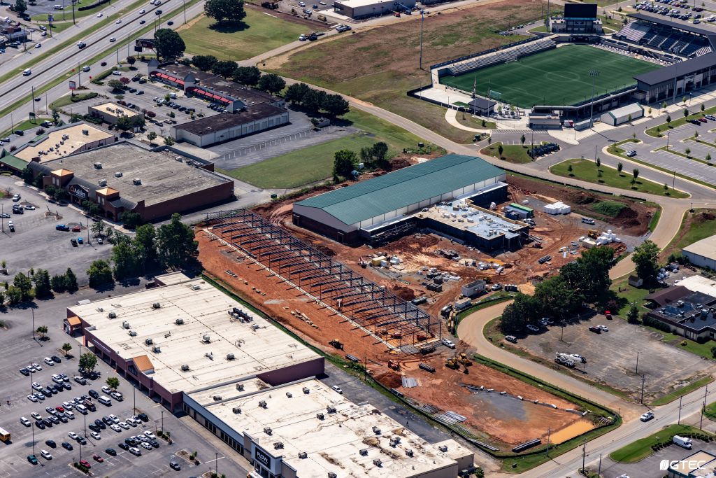 aerial photo of construction site with soccer stadium in the top right