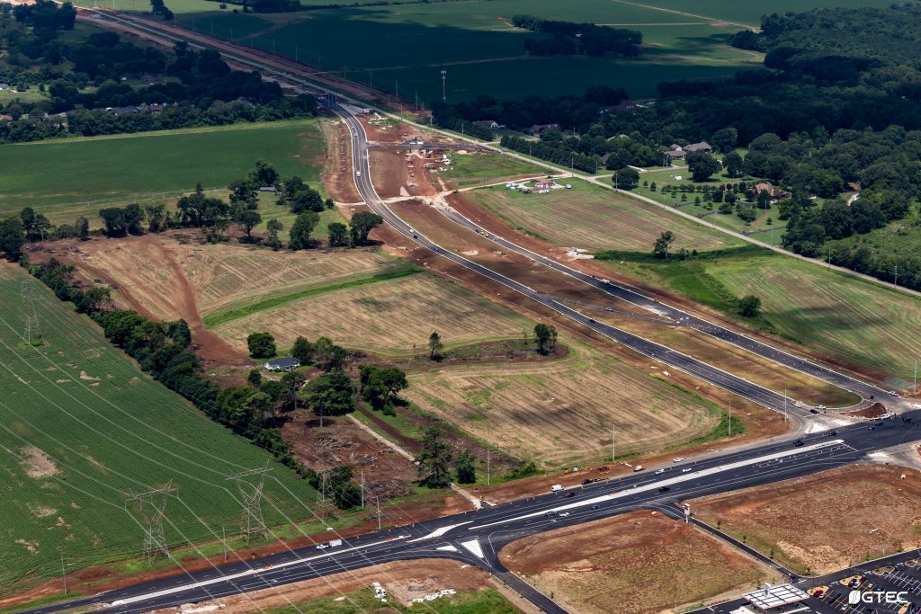 aerial photo of road construction through rural area of fields
