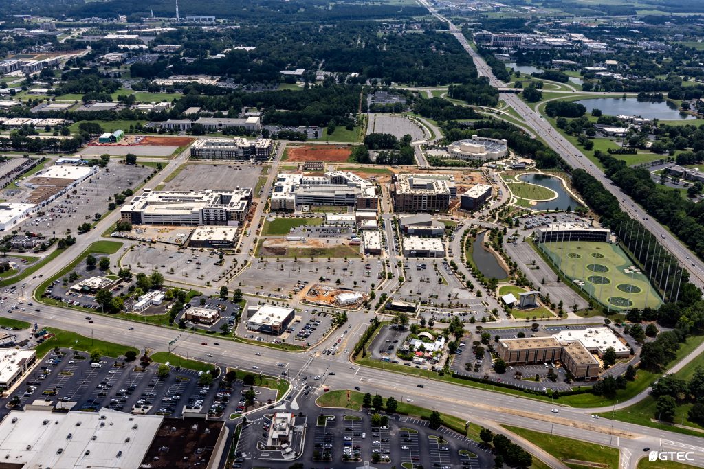aerial photo of large town framed by roads