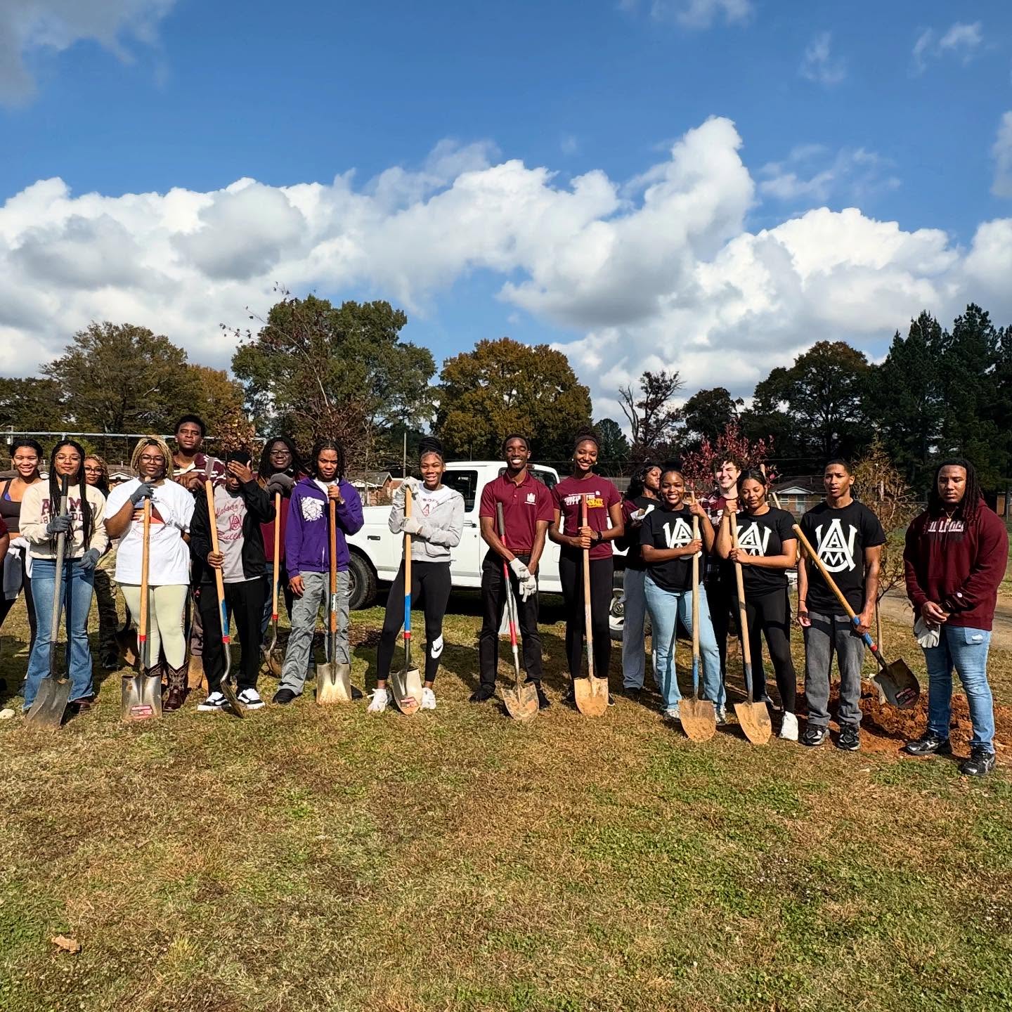 A very large group of community volunteers holding shovels at Cavalry Hill Tree Planting Day